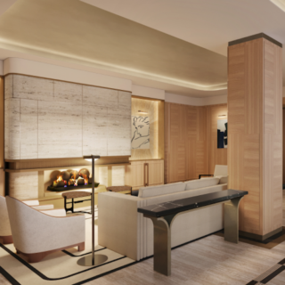 Modern hotel lobby lounge with beige sofas, cream chairs, and a lit fireplace