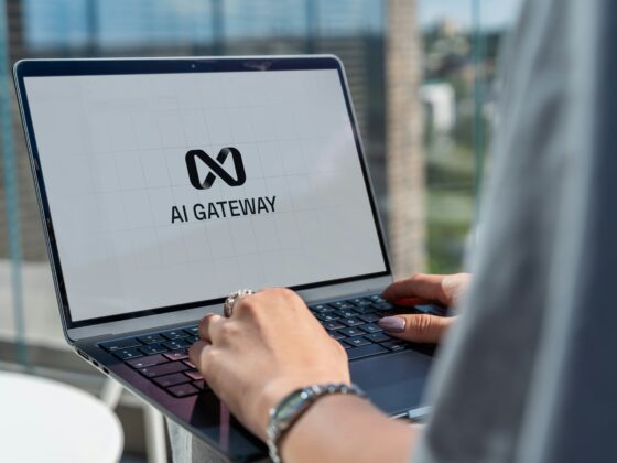 Close-up of hands typing on a laptop screen displaying the AI Gateway logo.