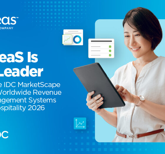 Smiling woman in a light blouse holds a tablet against a blue gradient banner; headline reads: "IDeas Is a Leader in the IDC MarketScape for Worldwide Revenue Management Systems in Hospitality 2026" with IDC logo.