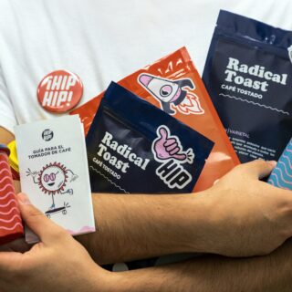 Person holding a variety of snack bags, a paper cup, and a badge reading 'CHIP HIP!' against a light blue background.