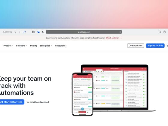 Airtable homepage hero with a laptop and phone showing automations workflow on a white page against a gradient backdrop.