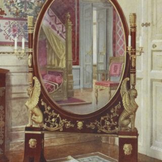 Elegant antique oval mirror on a gilded stand with sculpted figures, reflecting a doorway and pink upholstery in a richly decorated room.