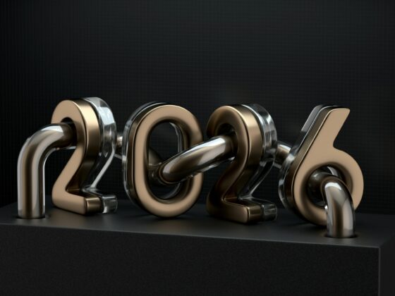 Shiny metallic 3D numbers forming '2023' on a black pedestal against a dark grid background.