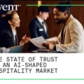 Cvent cover: two staff members discuss documents at a front desk, with the report title 'The State of Trust in an AI-Shaped Hospitality Market'.