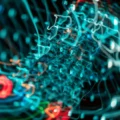 Blurred close-up of tangled blue and red network cables, suggesting chaotic data wiring in a tech setup.