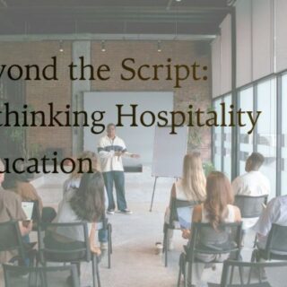 Presenter addresses an audience in a bright, modern space with large windows; overlay text reads 'Beyond the Script: Rethinking Hospitality Education'.