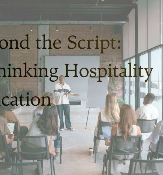 Presenter addresses an audience in a bright, modern space with large windows; overlay text reads 'Beyond the Script: Rethinking Hospitality Education'.