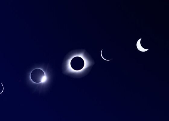 Sequence of crescent moons progressing toward a total solar eclipse on a dark blue gradient, with a small logo in the lower-right corner.