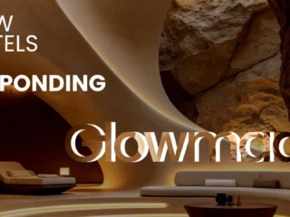 Lobby of a luxurious cave hotel with curved sandstone walls, warm ambient lighting, and modern seating; large white headline text overlaid about how hotels are responding to Glowmads (caption-like). Actress? (informative)