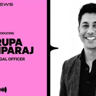 Intro card for Kirupa Pushparaj, Chief Legal Officer, on pink panel with a smiling man in a blazer beside it.