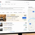 Desktop monitor showing Google search results for 'hotels in Paris' with hotel listings on the left and a Paris map on the right; Eiffel Tower visible through a window outside.