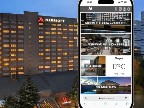 Marriott hotel exterior at dusk with a smartphone showcasing the hotel’s mobile app interface, displaying sections like Welcome, Restaurants, Hotel Services, and Discover Glasgow.