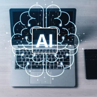 Laptop with a stylized cloud and circuit lines around an AI symbol, illustrating artificial intelligence.