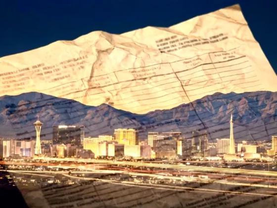 Night city skyline with mountains, overlaid by a crumpled sheet of paper containing text.