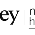 Logo showing the word 'journey' beside 'mastel hospitality' with a gold globe icon at the top right and a dividing line between the names.