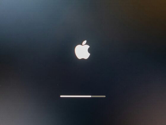Dark screen with a glowing white Apple logo and a thin progress bar near the bottom, suggesting macOS startup or update progress.