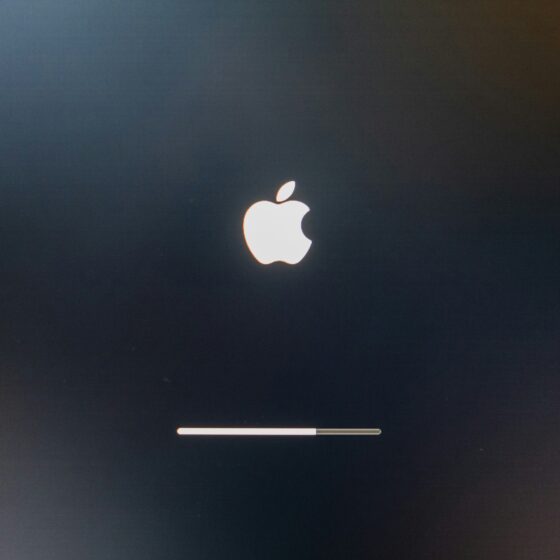Dark screen with a glowing white Apple logo and a thin progress bar near the bottom, suggesting macOS startup or update progress.