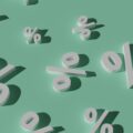Abstract scene with white 3D percent signs scattered on a mint green background.