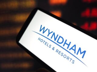 Smartphone screen showing the Wyndham Hotels & Resorts logo in blue on white.