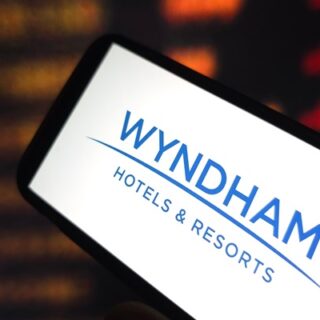 Smartphone screen showing the Wyndham Hotels & Resorts logo in blue on white.