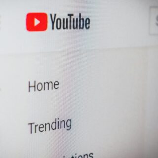 YouTube left navigation pane with the red Play button icon and labels like Home and Trending.