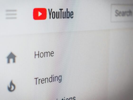 YouTube left navigation pane with the red Play button icon and labels like Home and Trending.
