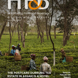 Magazine cover showing tea plantation workers harvesting tea leaves with woven baskets, overlaid with the H&B logo and subtitle 'Hospitality, Food and Beverage' in white text and the issue details, set in Assam, India.