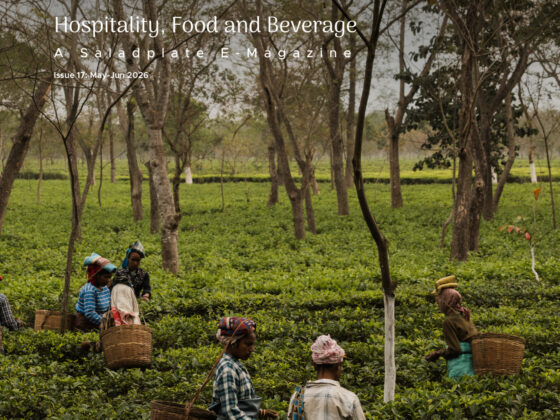 Magazine cover showing tea plantation workers harvesting tea leaves with woven baskets, overlaid with the H&B logo and subtitle 'Hospitality, Food and Beverage' in white text and the issue details, set in Assam, India.