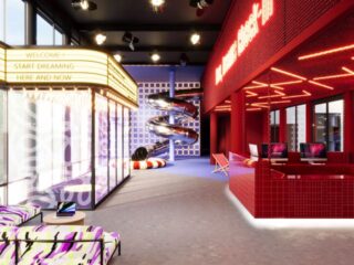 Colorful entertainment center interior with a yellow marquee, neon red bar, glass-walled lounge, and a spiraling slide in the back.