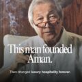 Portrait of an elderly man with glasses smoking, overlaid with text about founding Aman and transforming luxury hospitality.