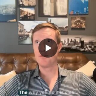 Host in a home studio speaking into a large Shure microphone, with wall art and Skift logo in the corner (GMH podcast).