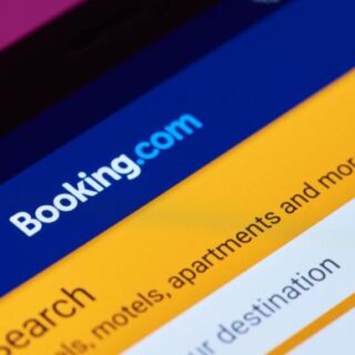 Booking.com mobile app screen with a blue header and an orange search area.