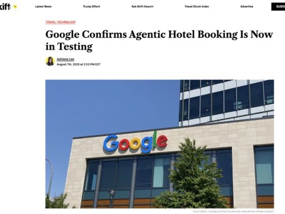 Google logo on the facade of a modern beige office building with glass windows and a tree in front