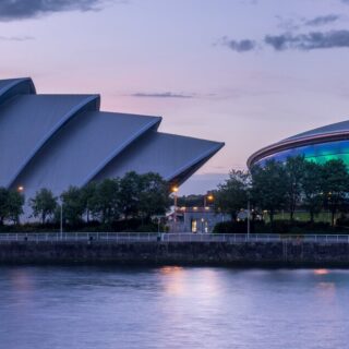 Twilight view of Glasgow's riverfront with the Armadillo (Clyde Auditorium) and SSE Hydro illuminated along the Clyde.
