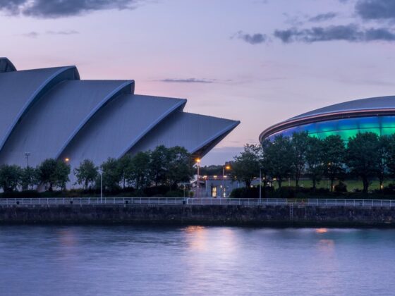 Twilight view of Glasgow's riverfront with the Armadillo (Clyde Auditorium) and SSE Hydro illuminated along the Clyde.