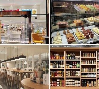 Storefront of a modern bakery café named Artisans, bright interior visible through the glass storefront.