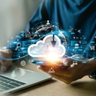 Person holding a glowing cloud icon above a laptop, illustrating cloud computing and data exchange.