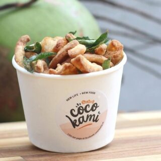 White cup of crispy fried snacks with green herbs, Coco Kami logo on the front.