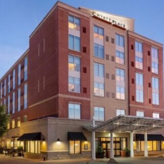 Exterior of a Hyatt Place hotel with brick façade, multiple stories, and a covered entrance at street level.