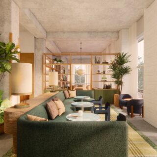 Open-concept lounge with a green sectional, round glass tables, and tall shelves filled with plants and decor