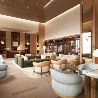 Luxurious hotel lobby with light wood floors, teal rounded chairs, and warm ambient lighting.