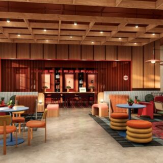 Modern lounge with warm wood paneling, a back-lit red bar, and colorful seating including round ottomans and chairs.