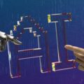 Robotic hand and human hand reaching toward a transparent geometric lattice, symbolizing human–machine collaboration against a blue circuit-board backdrop.
