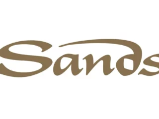Sands logo: brown cursive wordmark on a white background