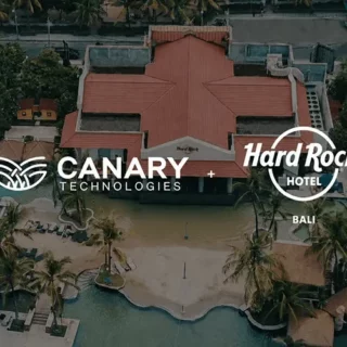 Aerial view of a tropical resort with a red-roof building and blue pools, overlaid with Canary Technologies and Hard Rock Hotel Bali branding (partnership).