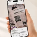 Hand holding an iPhone displaying an Instagram post with a newspaper front page that reads “BREAKING NEWS” and “LA CONCHA TURNS 100.”] ,