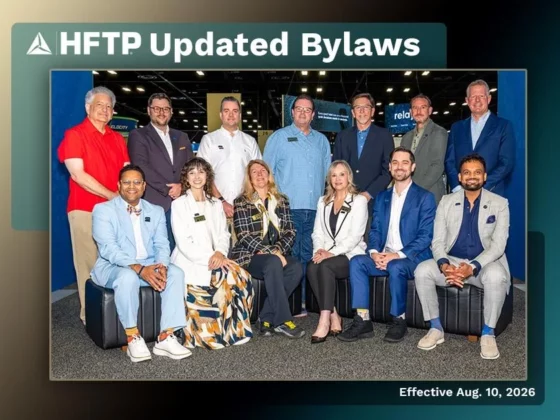 Group of twelve professionals posing in a convention hall for the HFTP Updated Bylaws announcement.