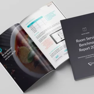 Open in a gray background: a dark report cover titled 'Room Service Benchmark Report 2026' beside an open magazine showing a dish photo and data pages.