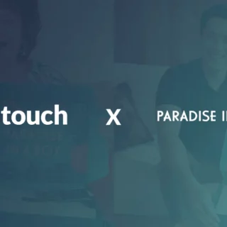 Collaboration banner showing Stayntouch and Paradise in a Box logos with an X between them on a teal background.