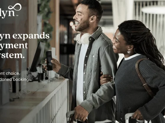 Cendyn logo with a man and woman at a service counter, travelers with luggage, conveying a payment-ecosystem promo.